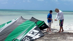 Mike teaches a young kiteboarding student shoreside.